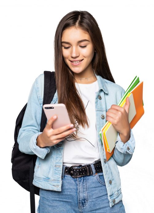 Portrait of happy young woman standing with backpack and mobile phone